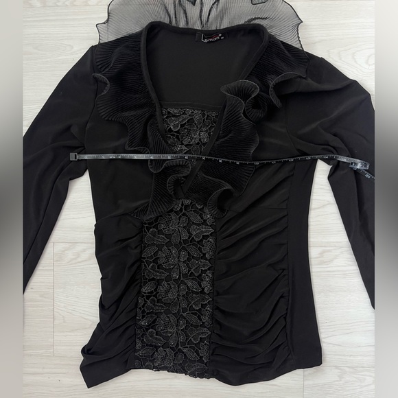 black long-sleeved women's blouse featuring a ruffled neckline and floral lace - Picture 3 of 6